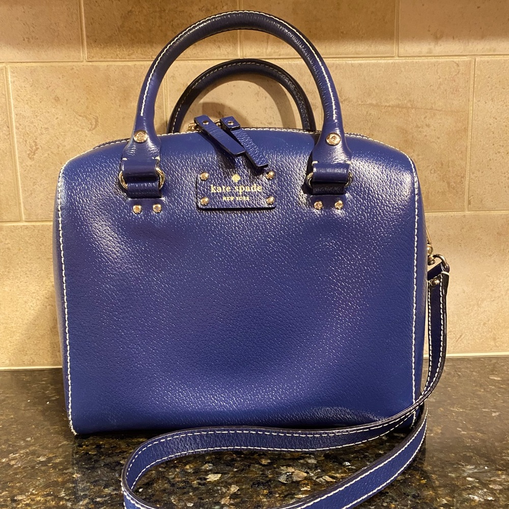 Kate Spade purse, navy blue with polka dot lining inside. Gold metal accents.